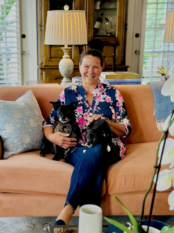 Missy at home with her dogs on living room sofa